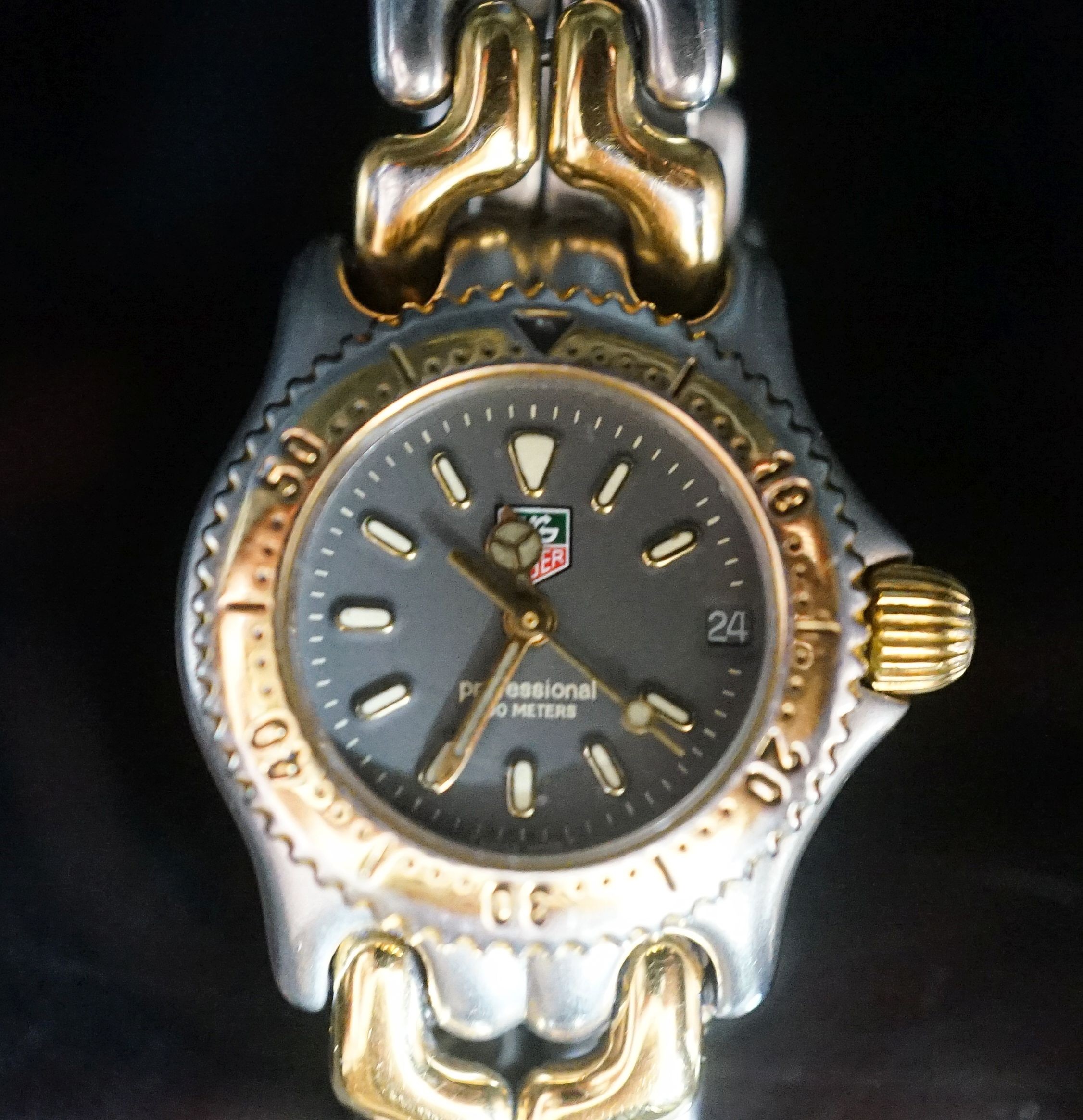 A lady's modern steel and gold plated Tag Heuer Professional quartz wrist watch, no box or papers.